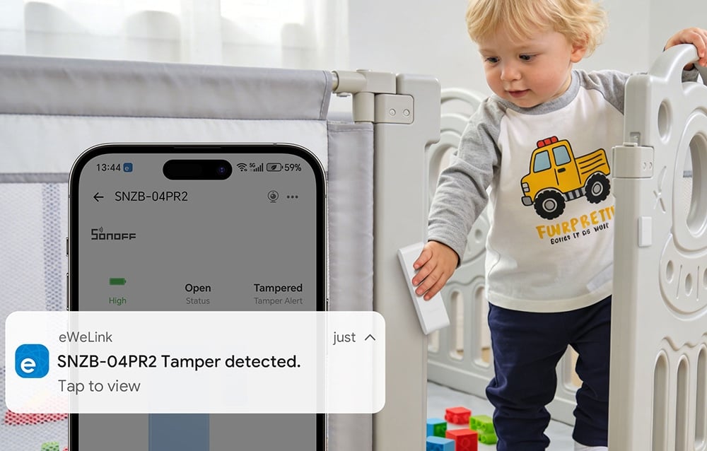 A child climbing out of a crib, next to a smartphone displaying a notification