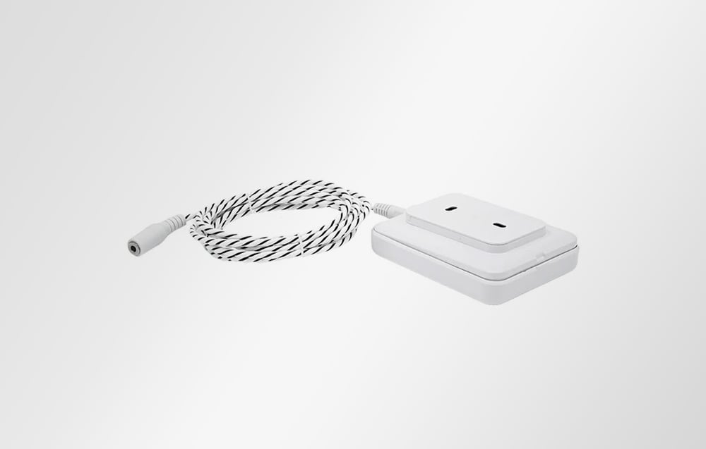 Flood sensor with attached stand and black and white cable on white background