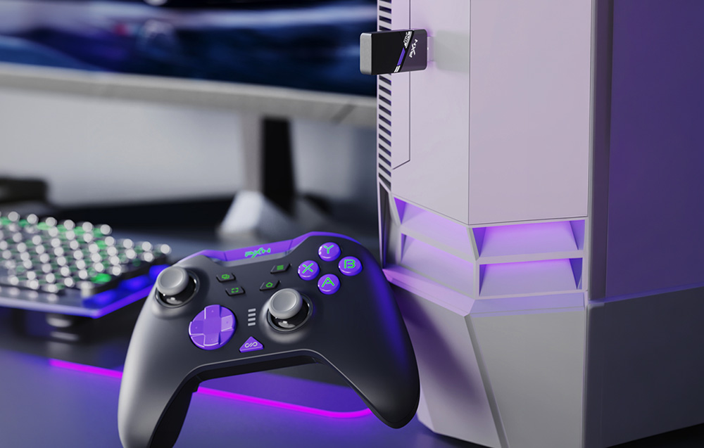 Black game controller and white console with purple backlighting on a gamer’s desk