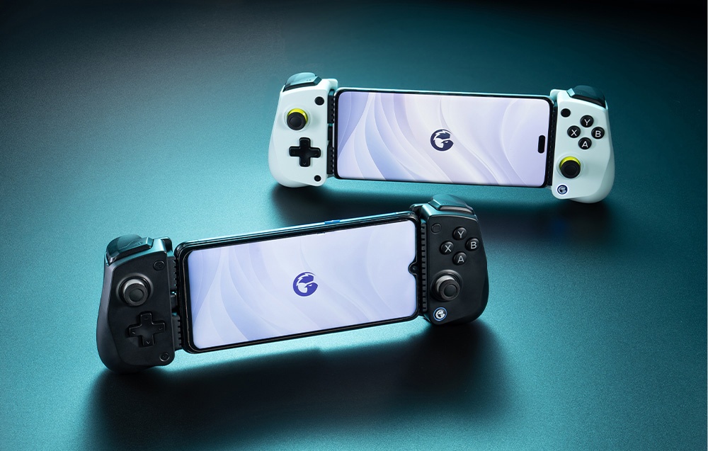 Two GameSir controllers with smartphones attached - one white and one black - set on a blue surface.