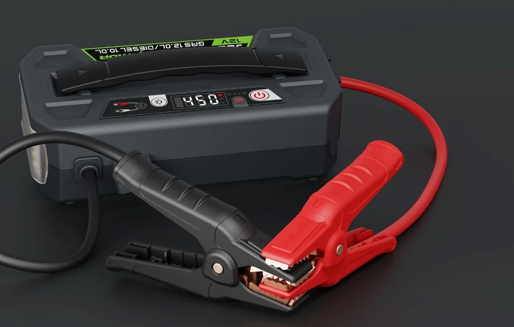 A close-up of the device with the jump-start clamps open, ready for use, showing the details of the clamps.