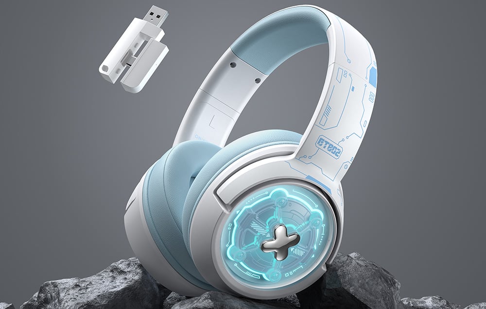 White gaming headphones lying on dark rocks, with a USB adapter next to them