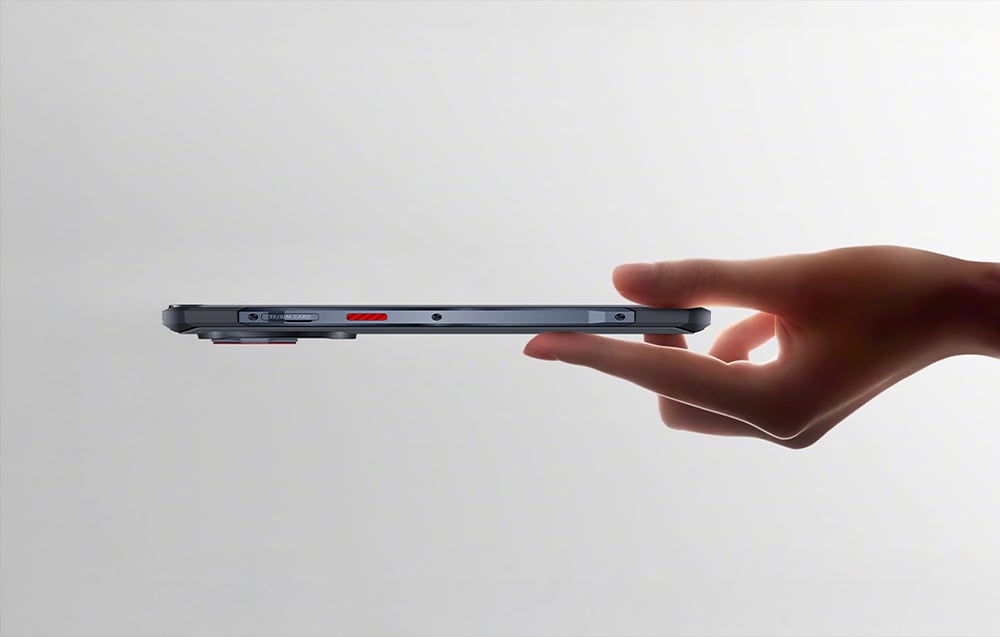Side view of the slim profile of the smartphone held in the hand, highlighting the function button and card slot.