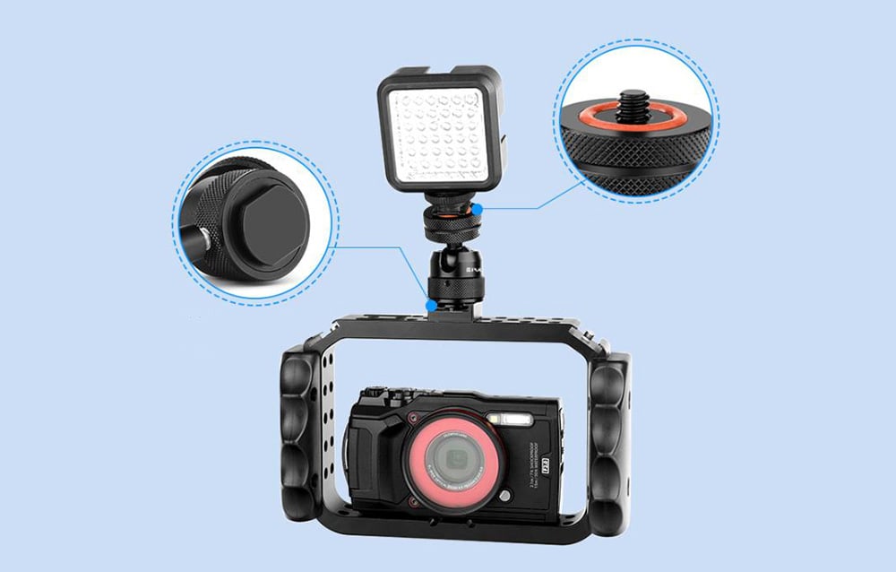 Camera in cage with LED lamp and ball head with description of elements on blue background