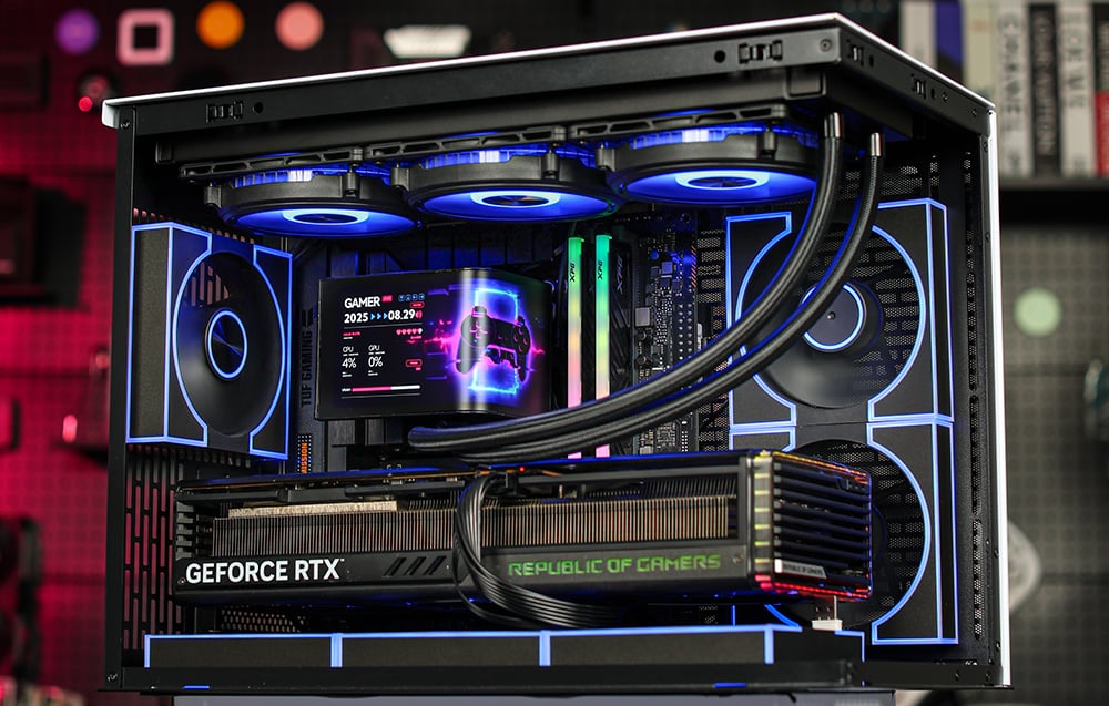 Inside a desktop PC with illuminated water cooling, an RTX graphics card, and an LCD screen on the CPU