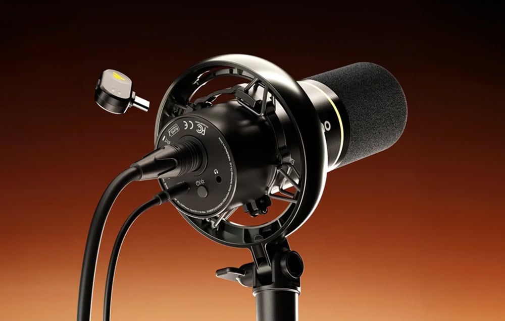 A Maono microphone on a tripod with cables connected and a USB-C wireless receiver on the side
