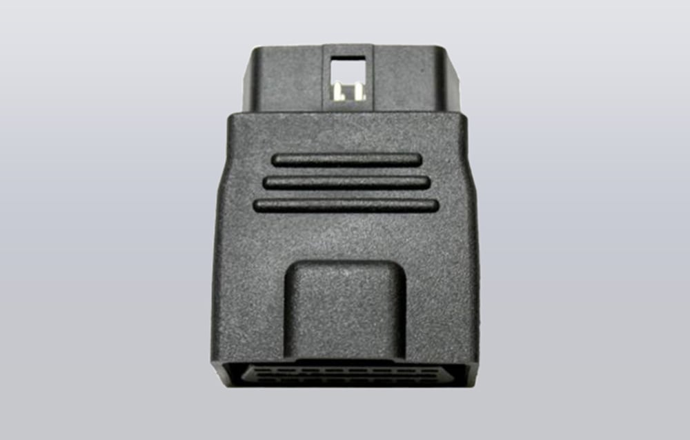 Black OBD-II extension adapter on a gray background