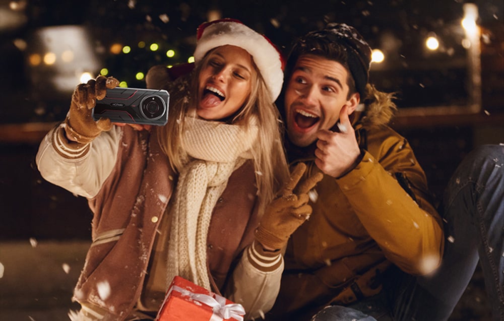 Man and woman in winter clothes taking a selfie with a Hotwav smartphone