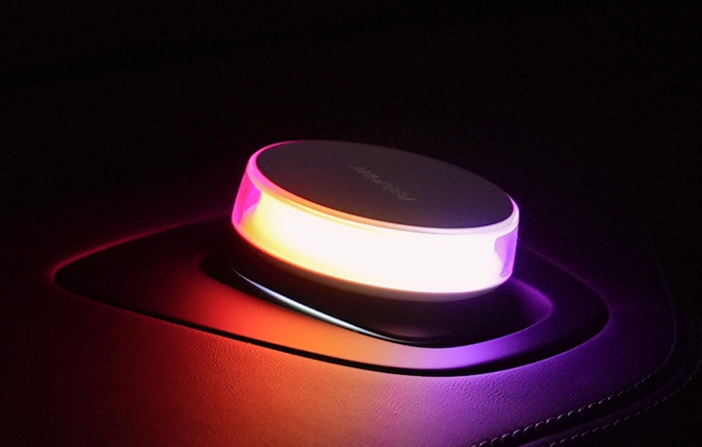 Yeelight Vega lamp in the car, shining with an intense pink-orange light.
