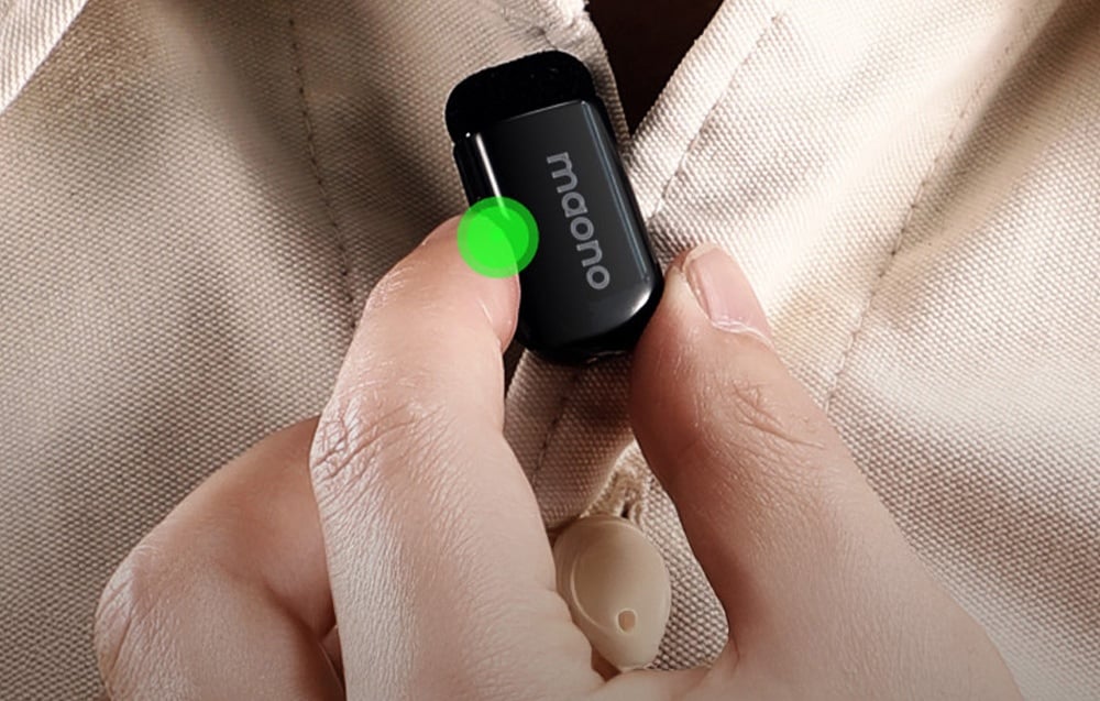 Close-up of Maono WM622 PC2 microphone connected to cream shirt