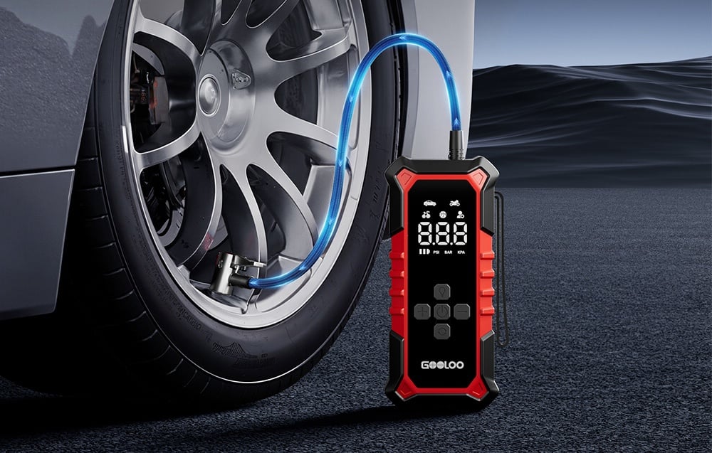 GOOLOO portable compressor connected to a car tire on the road