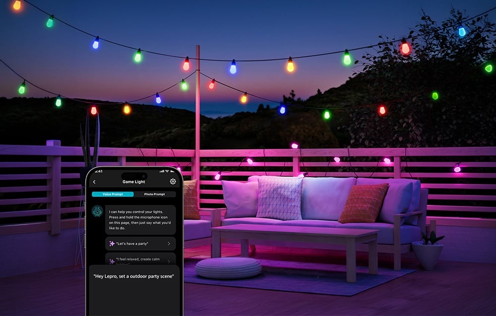 A colorful string of lights above a terrace with a sofa; in the lower left corner, a smartphone screen with voice command functionality.