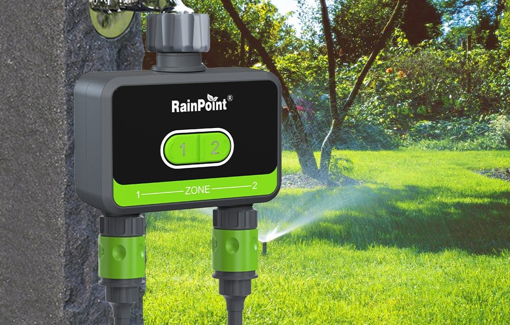 RainPoint irrigation controller in green color, behind it is the garden.