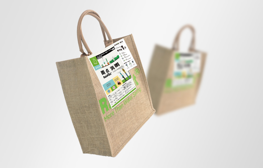 Two RainPoint jute bags suspended in the air against a light background; one in sharp focus in the foreground, the other blurred in the background