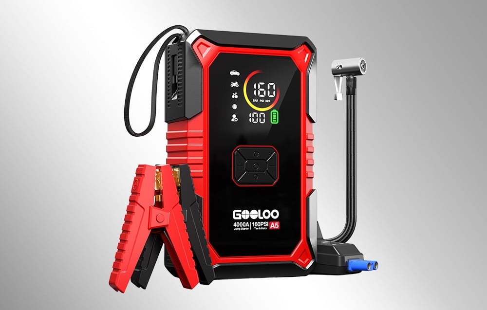 Black and red Gooloo A5 jump starter with clamps and compressor hose on a gray background