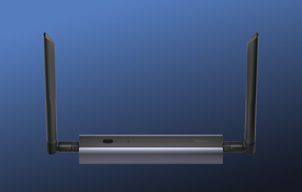 ZigBee Sonoff gateway with black antennas on dark blue background.
