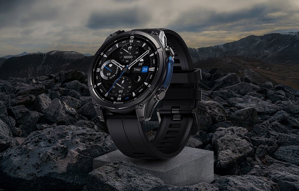 Black smartwatch set on a gray block with a mountainous landscape in the background