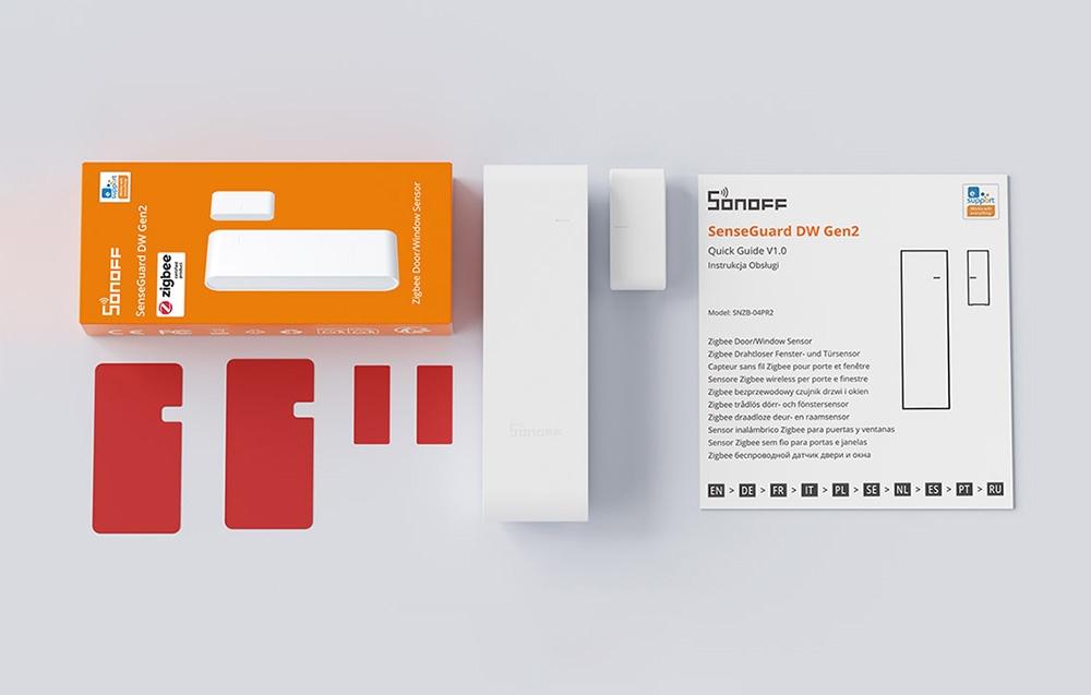 Sensor with mounting accessories, packaging, and user manual on a light-colored background