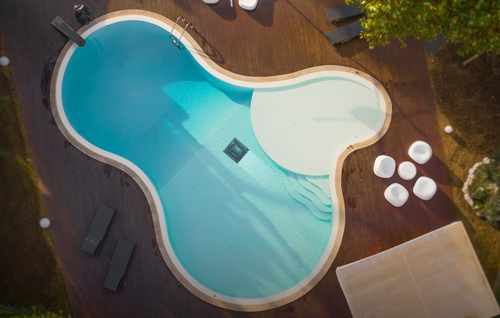 Top view of the Wybot M2 robot cleaning an irregularly shaped pool