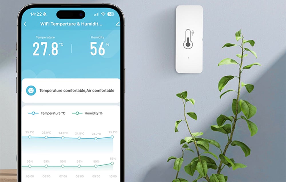 Temperature and humidity sensor on a wall next to a potted plant, with a smartphone app showing readings of 27.8°C and 56%