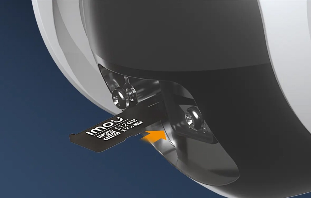 A 512GB Imou Micro SD memory card being inserted into a slot in the black part of the camera housing