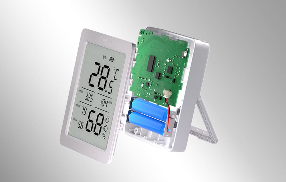 The Sonoff sensor is unfolded, showing the electronics and space for two AAA batteries inside the housing.