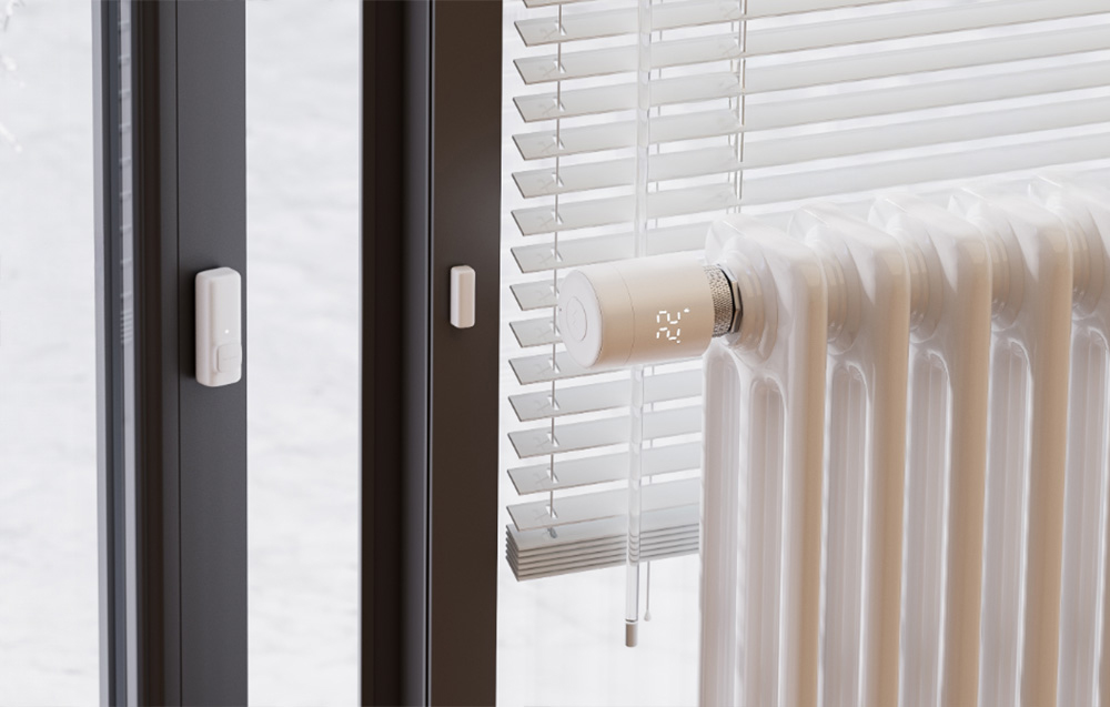 Radiator with thermostat next to the balcony door