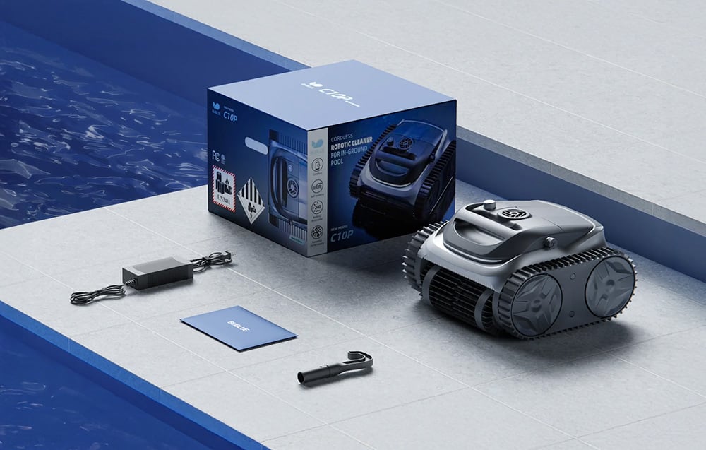 The Bubot 700 pool robot at the edge of the pool next to the box, charger, and user manual