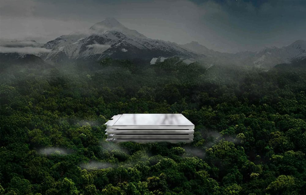 Lokithor battery cells against the backdrop of a dense, green forest and snow-capped mountain peaks.