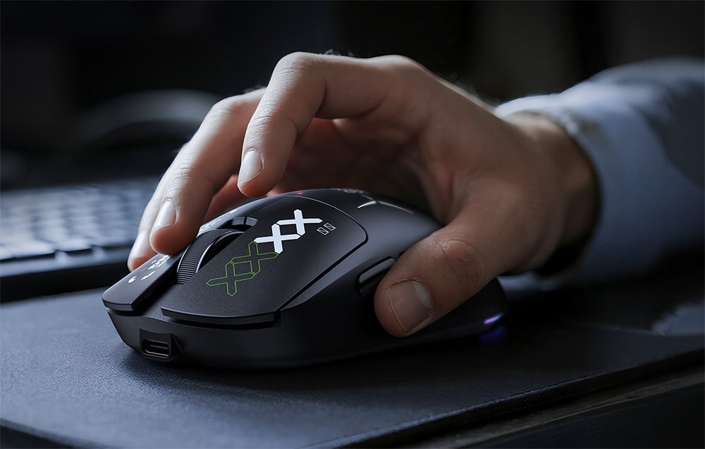 Close-up of a hand resting on a black computer mouse