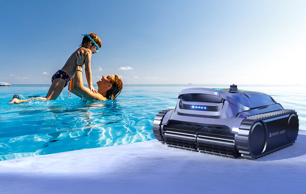 Mother and child in the pool next to the pool robot Wybot on the bank