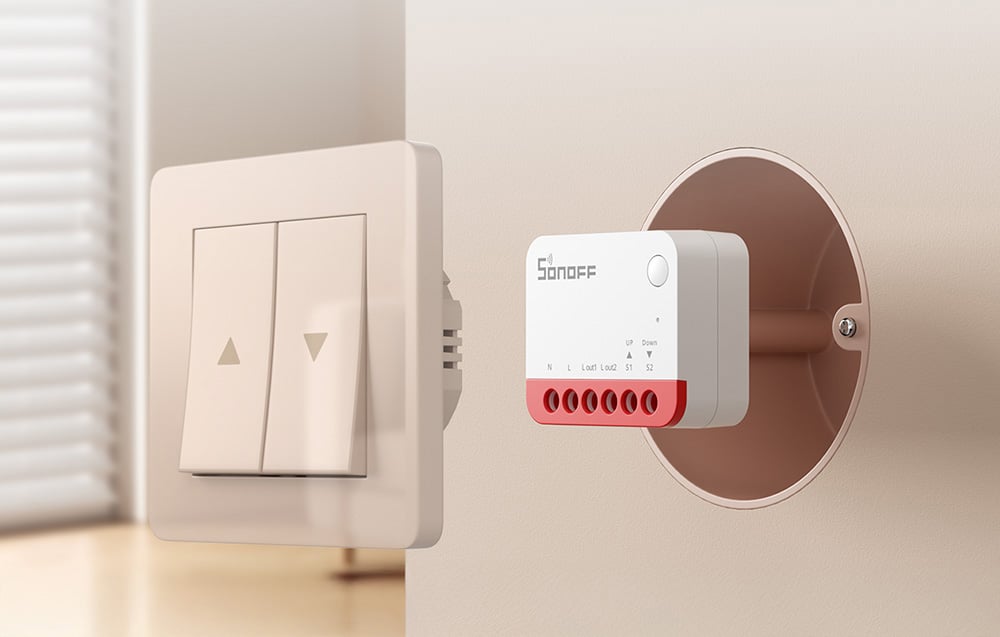 Wall switch with up and down buttons and SONOFF MINI module mounted in an installation box.