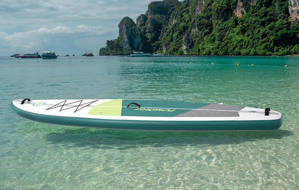 Colorful surfboard on the water, with ships and mountains in the background