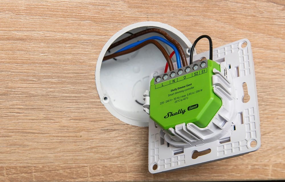 Side view of the wall-mounted controller, showing the arrangement of electrical wires inside the junction box.