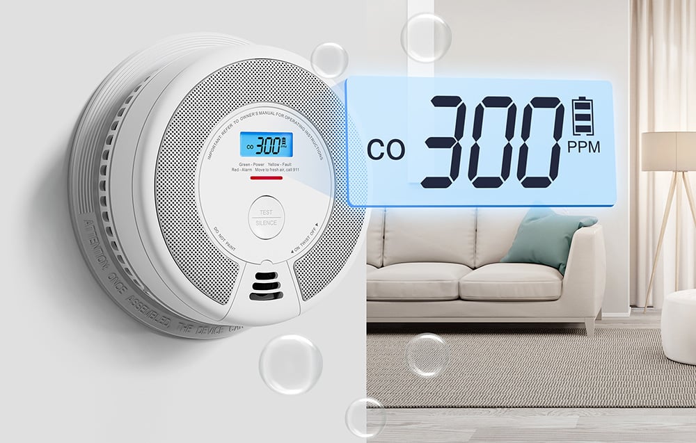 A carbon monoxide sensor on the wall with a magnified LCD display showing a concentration of 300 PPM and the battery status