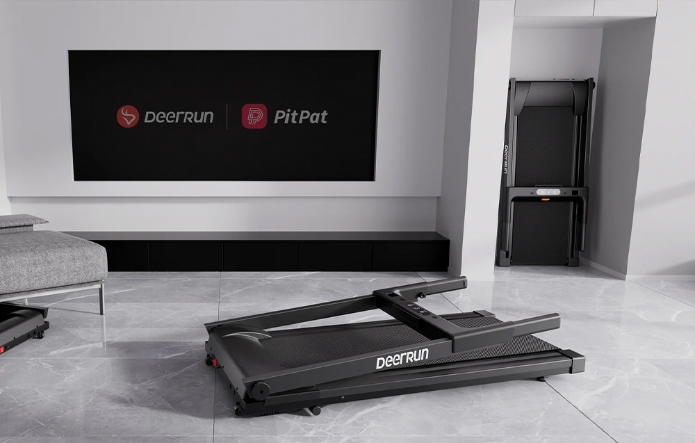 DeerRun treadmill set up in a living room, with one unfolded and the other folded against the wall