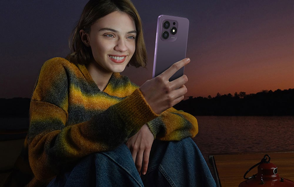 Woman in a yellow and green sweater using a Hotwav smartphone