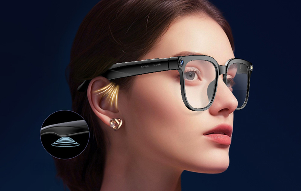 A woman in profile wearing glasses that direct sound directly to her ear via sound waves.