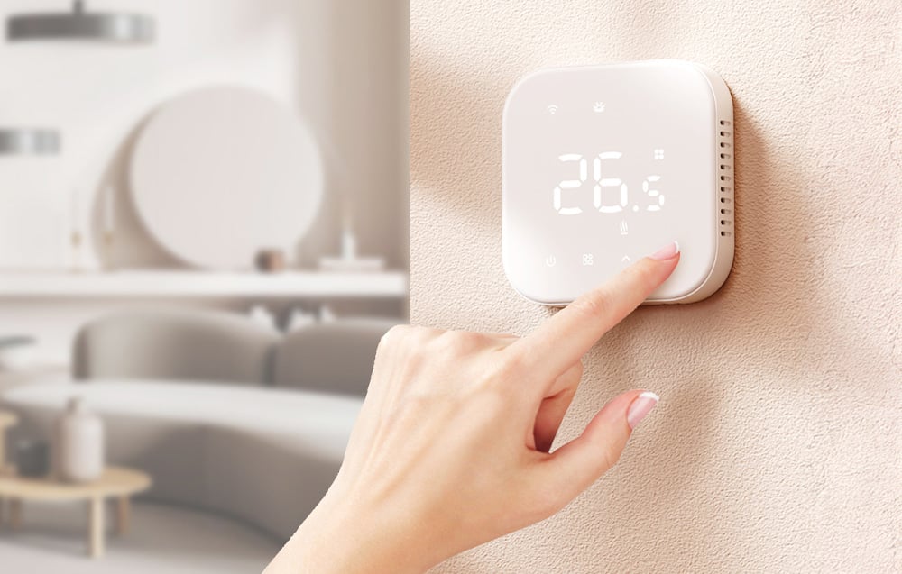 White Meross smart thermostat on a beige wall in the living room