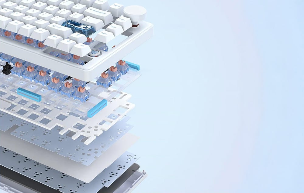 White keyboard laid out in several pieces on a blue background