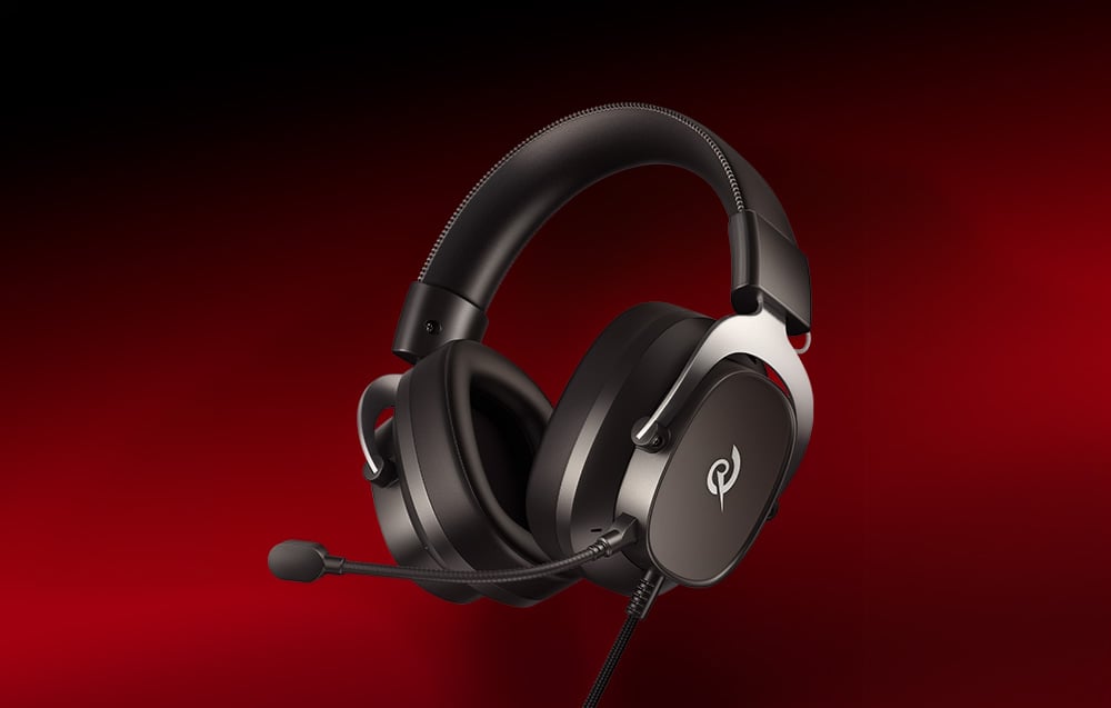 Black gaming headphones with a microphone on the headband, angled against a solid red background
