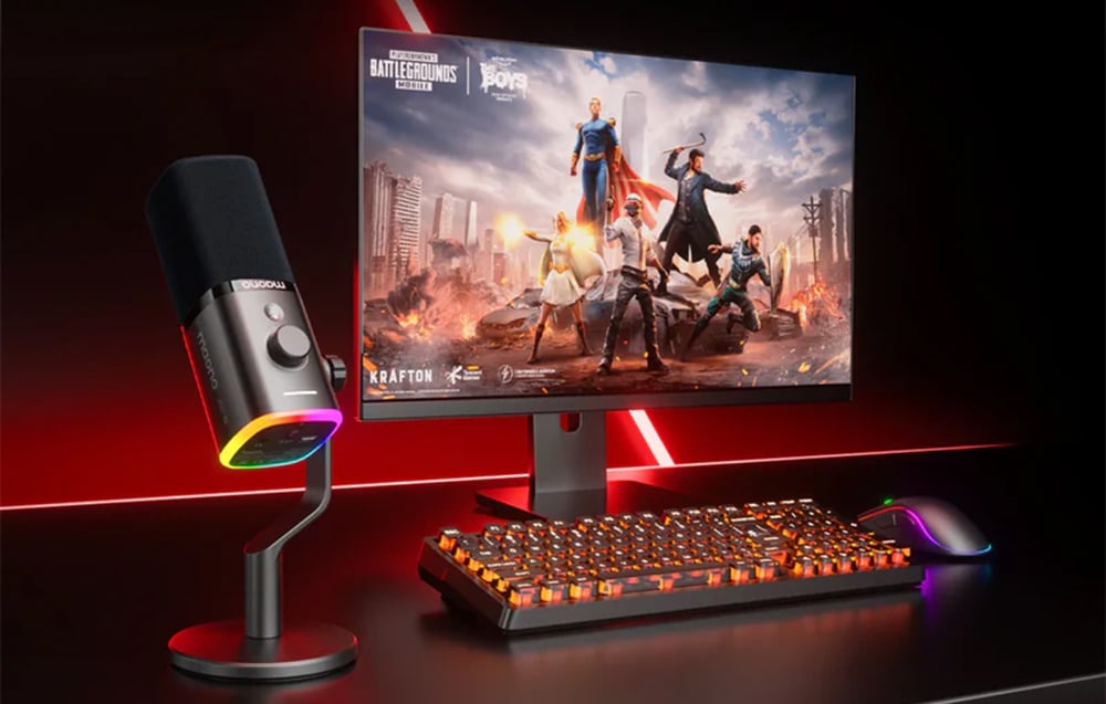 A gaming setup with a monitor, keyboard, mouse, and Maono microphone with colorful backlighting