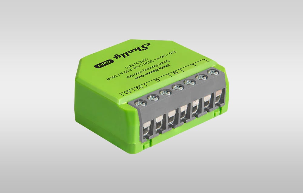Green lighting controller shown at an angle, displaying rows of screw terminals for connecting the wiring.