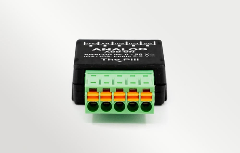 A connector with screws on a white surface, with visible text on the black housing next to it