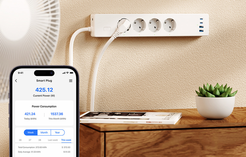 Power strip with connected device and smartphone screen showing current power consumption and statistics