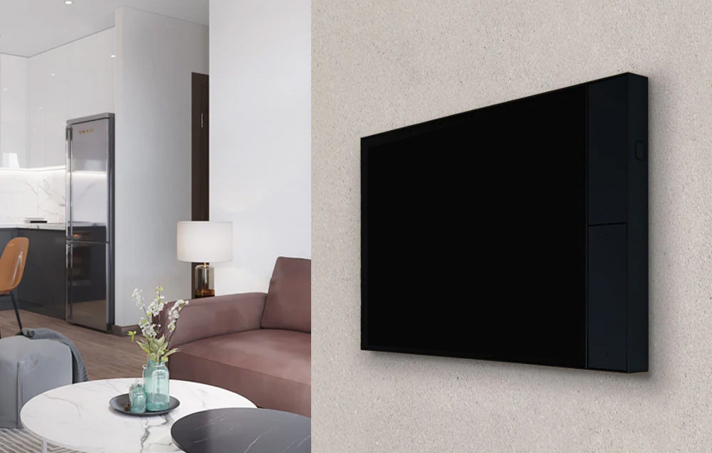 Black touch panel on beige wall in living room with pink sofa and white table