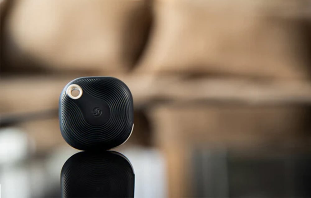 Black scene activation button placed on a dark table
