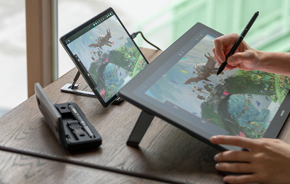Close-up of graphics tablet at work with monitor and stylus visible