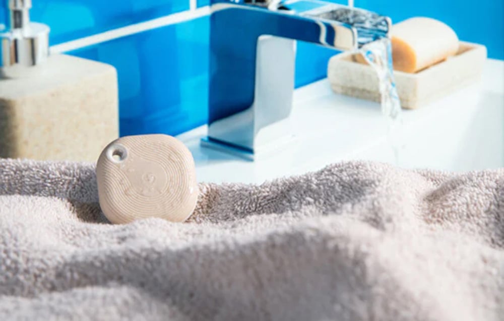 Scene activation button located on a towel next to the sink in a blue bathroom