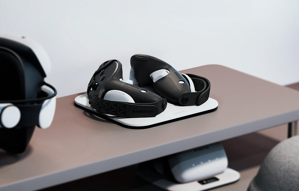 Two VR controllers on the BoboVR CD3 charging station placed on a desk